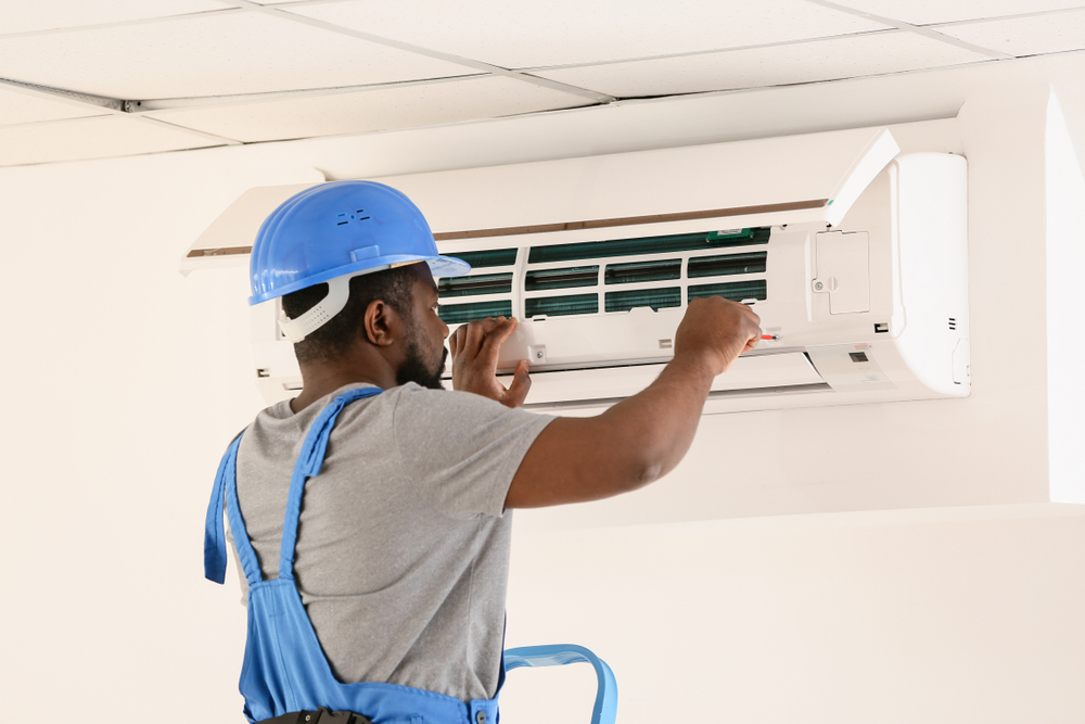 Technician doing maintenance of an air conditioner